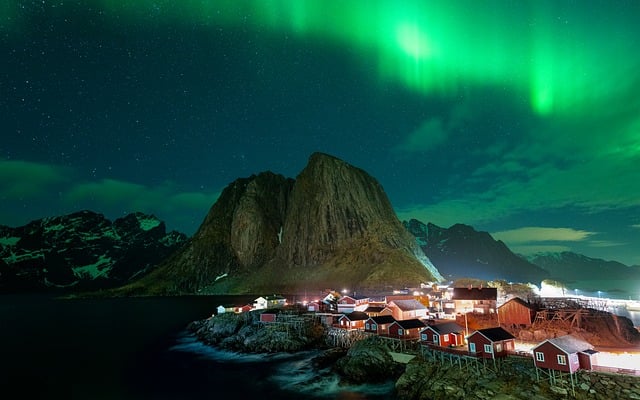 Waterfall air in Norway where fjords hold pale light late into night